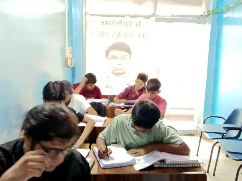 Students writing in their notebooks in the DSM Classes classroom